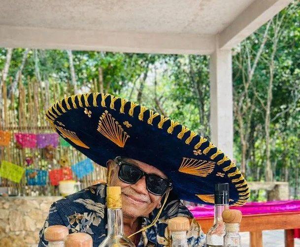 A guest in a big charro sombrero at the tasting table