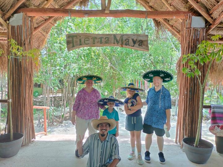 Four guests in charro sombreros at the entrance arch