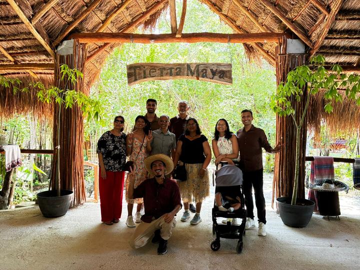 Family with a stroller, guide kneeling