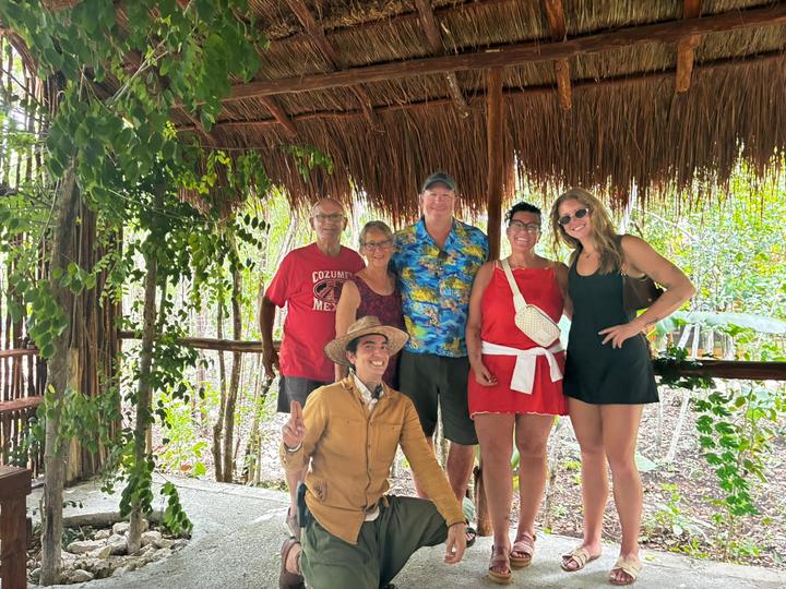 Five guests with guide kneeling, at the side entrance