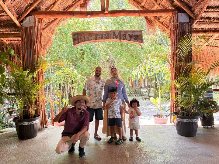 Family with two small kids, guide kneeling